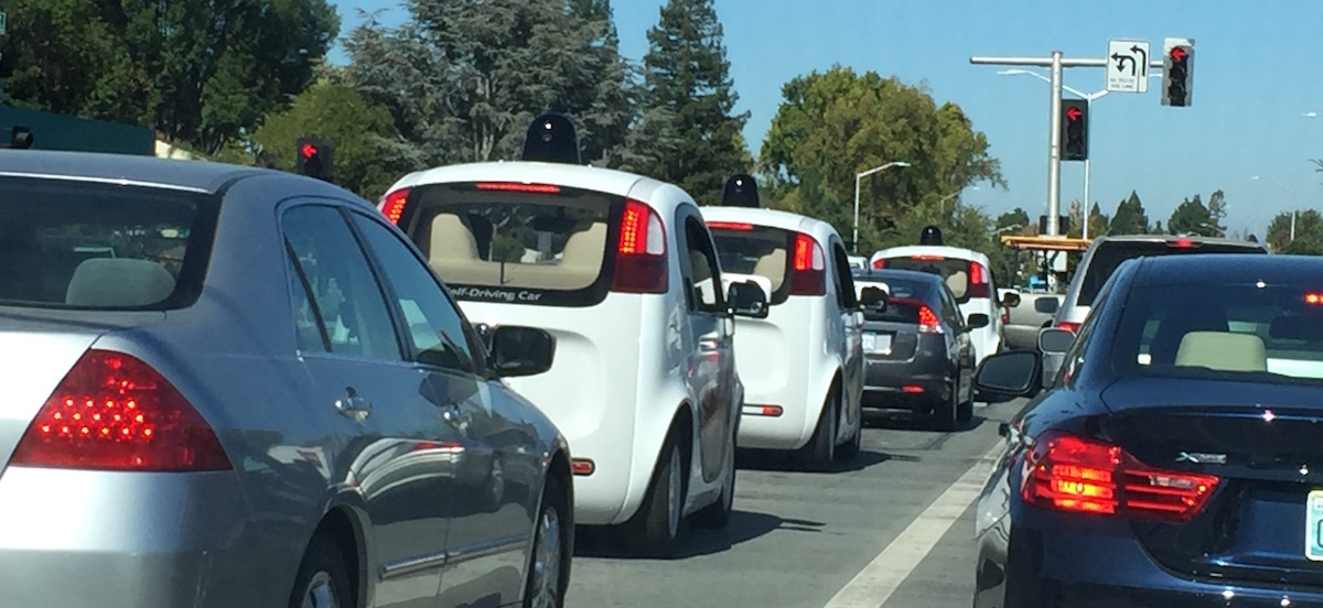 Three Google self-driving cars at the traffic light